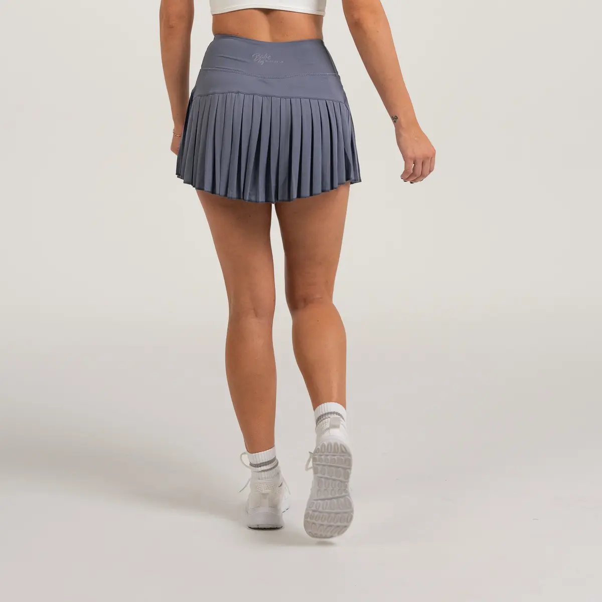 Image of Babe Pleated Skirt – Flattering & Sporty Athleisure - Color - Blue - Blue Logo - 3 / 6